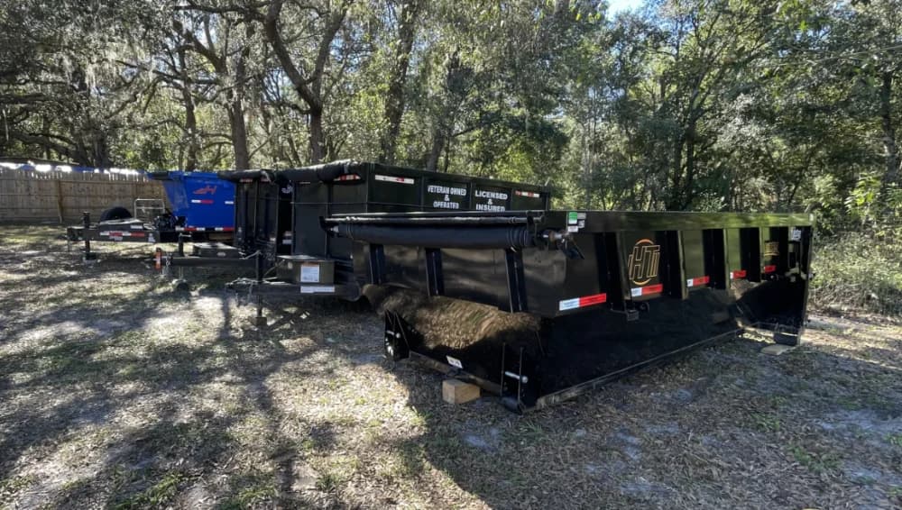 Four dumpsters lined up next to each other